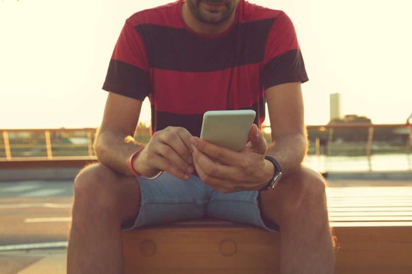 A man using a dating app on his mobile in search of a partner