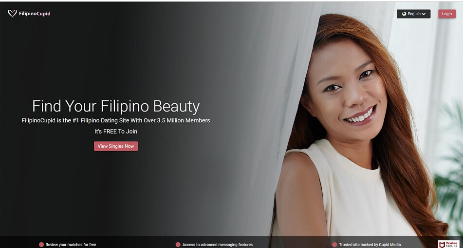 pretty filipina standing by a curtain looking into camera smilingly. 