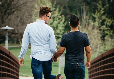 gay couple holding hands and taking a walk