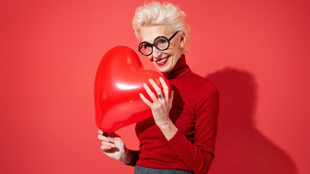 attractive granny holds heart balloon