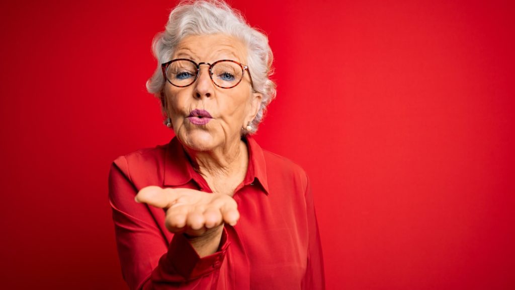 Attractive granny blows kiss to her potential date