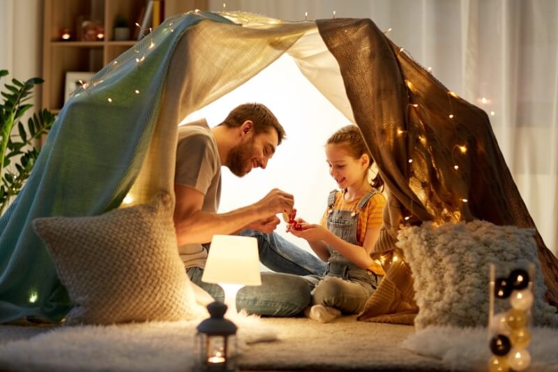 single dad has built an indoor tent with his daughter and they're having a tea party