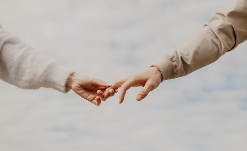 two people taking each other's hand