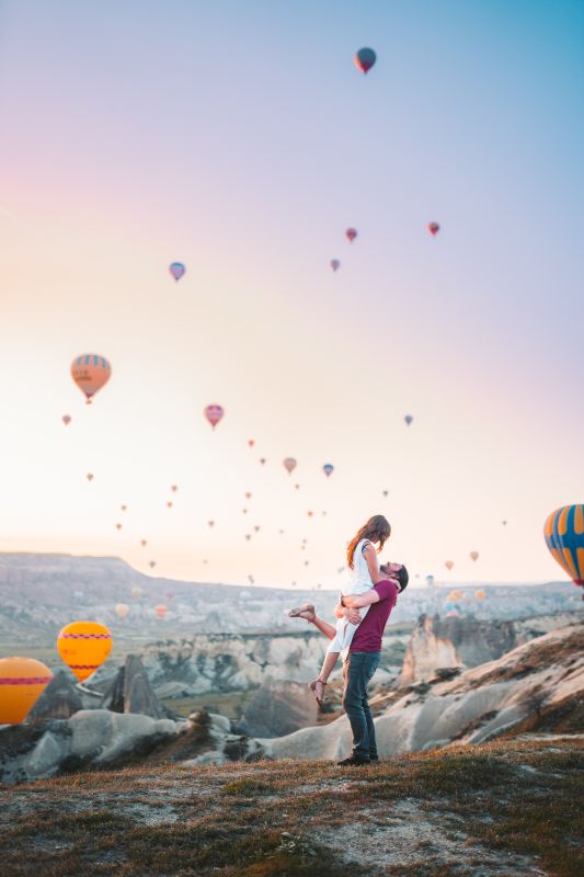 Couple celebrating their relationship with balloons in the background